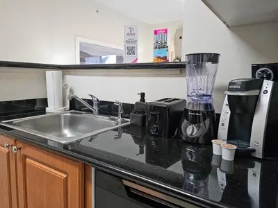 a kitchen counter with a sink and a blender at 2BR 2BA Grand Duo Suite Sleeps 8 Near Universal and I Drive in Orlando
