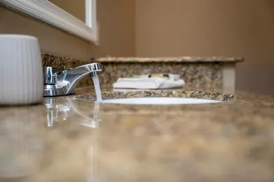 a bathroom counter with a sink and aaucet at WorldQuest Orlando Resort in Orlando