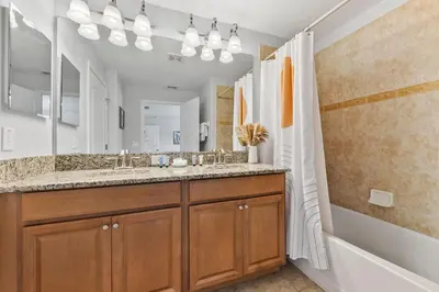 a bathroom with a double sink and a shower at 8847 Candy Palm Rd in Kissimmee