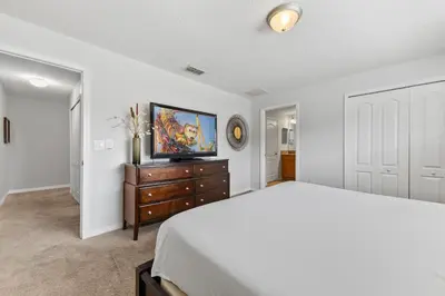 a bedroom with a bed and a tv on a dresser at 8847 Candy Palm Rd in Kissimmee