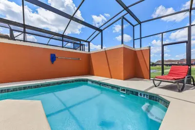a swimming pool in a building with a chair at 8847 Candy Palm Rd in Kissimmee