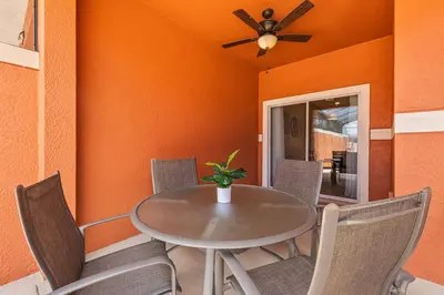 a dining room with a table and chairs at 8847 Candy Palm Rd in Kissimmee