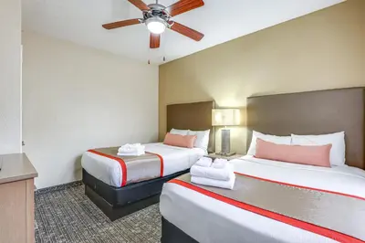 a hotel room with two beds and a ceiling fan at Poolside Oasis 7 Mi to Disney and Universal in Orlando