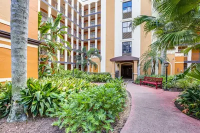 a building with a pathway in front of a building at Poolside Oasis 7 Mi to Disney and Universal in Orlando
