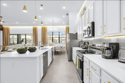 a large kitchen with white cabinets and appliances at Epic Paradiso Mansion-Pool,Game Room,Theater-4 in Orlando