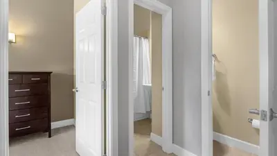 a bathroom with a mirror and a dresser in a room at Sunny Summer Magic - Stay in TownHome by Disney in Orlando
