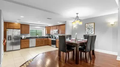 a kitchen with a dining room table and chairs at Sunny Summer Magic - Stay in TownHome by Disney in Orlando
