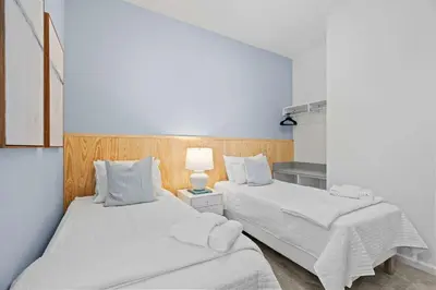 two beds sitting next to each other in a room at Casa Luxo 5 Suítes | Perto da Epic Universe in Orlando