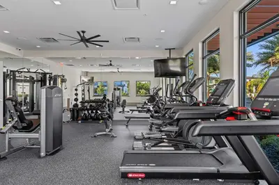 a gym with a bunch of treadmills and machines at Casa Luxo 5 Suítes | Perto da Epic Universe in Orlando
