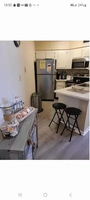 a kitchen with a counter and two stools in it at Cozy 2 bedroom Orlando apartment in Orlando