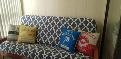 a couch with three pillows on top of it at Cozy 2 bedroom Orlando apartment in Orlando