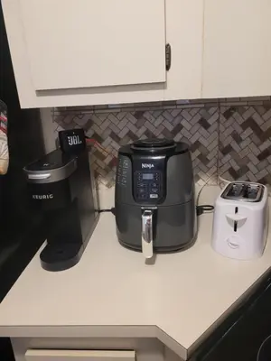 a coffee maker and a toaster on a counter at Cozy 2 bedroom Orlando apartment in Orlando