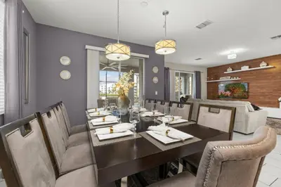 a dining room with a table and chairs at Luxe Lakeview Private Pool SPA 10 Min Disney in Kissimmee