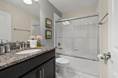 a bathroom with a sink and a toilet and a shower at Luxe Lakeview Private Pool SPA 10 Min Disney in Kissimmee