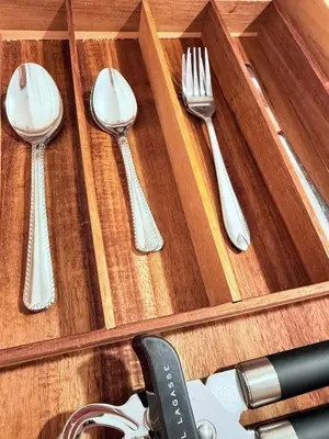 four utensils in a wooden box with forks and knives at Modern Studio with Exterior Independent Entrance in Orlando