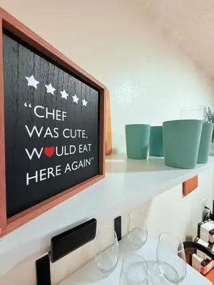 a shelf with wine glasses and a chalkboard at Modern Studio with Exterior Independent Entrance in Orlando