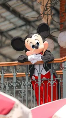 a statue of a mickey mouse sitting on a fence at Modern Studio with Exterior Independent Entrance in Orlando