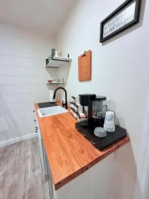 a kitchen counter with a sink and a coffee maker at Modern Studio with Exterior Independent Entrance in Orlando