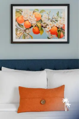 a picture of oranges and flowers above a bed at Lake View Top Floor 2 Bed 2 Bath Condo with Balcony in Orlando