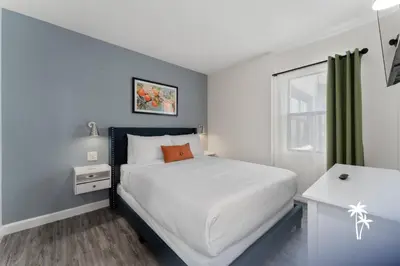 a small bedroom with a bed and a window at Lake View Top Floor 2 Bed 2 Bath Condo with Balcony in Orlando