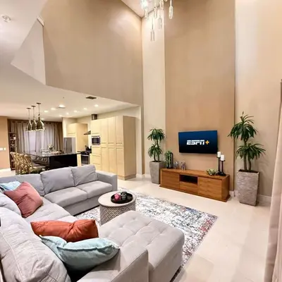 a living room with a couch and a tv at Spacious 4-Suite Villa with Balcony, Magic Village in Orlando