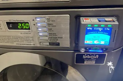a machine with a clock on the side of it at Skyline Studio Condo with Private Terrace and Epic Universe View in Orlando