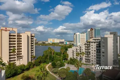 a city with tall buildings and a body of water at Skyline Studio Condo with Private Terrace and Epic Universe View in Orlando