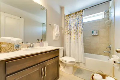 a bathroom with a sink and a toilet and a shower at Pool Access Family Gem with Views in St Cloud! in Saint Cloud