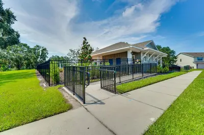a gate in front of a house at Pool Access Family Gem with Views in St Cloud! in Saint Cloud