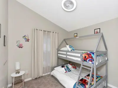 a bedroom with a bunk bed with a ladder at Castle Keys Salt Water Pool Home 10 mins to Disney in Kissimmee