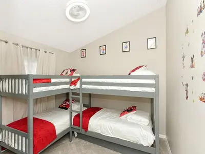 two bunk beds in a childs bedroom at Castle Keys Salt Water Pool Home 10 mins to Disney in Kissimmee