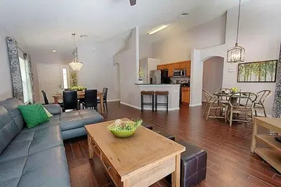 a living room with a couch and a table at Poolside Vacation Home in Kissimmee Near Disney in Kissimmee