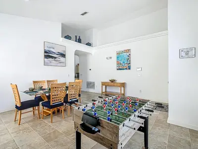 a ping pong table in a living room at Themed 4BR villa w spa & pool-Close To Disney in Orlando