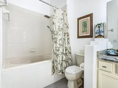 a bathroom with a tub and a toilet and a sink at Themed 4BR villa w spa & pool-Close To Disney in Orlando