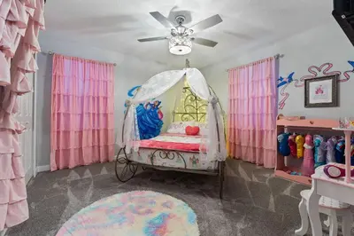 a room with a bed with a ceiling fan at NEW 9Bdrm S. Facing Pool on Preserve near Dis/Univ in Kissimmee