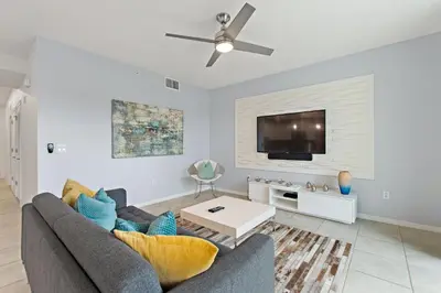 a living room with a couch and a tv at Sunset Retreat at Storey Lake Resort by Shine Villas condo in Kissimmee