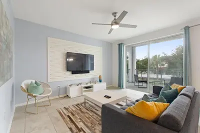 a living room with a couch and a tv at Sunset Retreat at Storey Lake Resort by Shine Villas condo in Kissimmee