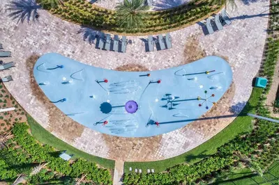 an overhead view of a swimming pool with people in it at Sunset Retreat at Storey Lake Resort by Shine Villas condo in Kissimmee