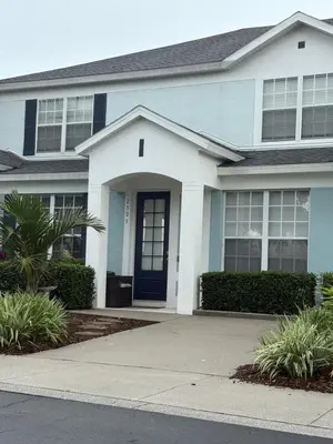 a blue and white house with a blue door at Relaxing vacation resort villa in Orlando