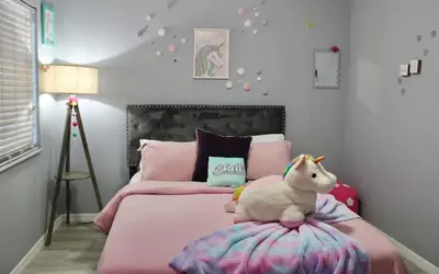 a bedroom with a bed with a stuffed horse on top of it at Level Up Your Vacation Stylish Home Near Disney in Kissimmee