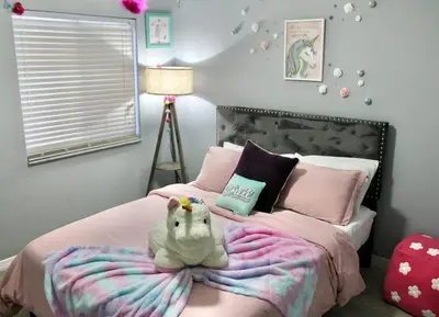 a bedroom with a bed with a stuffed animal on it at Level Up Your Vacation Stylish Home Near Disney in Kissimmee