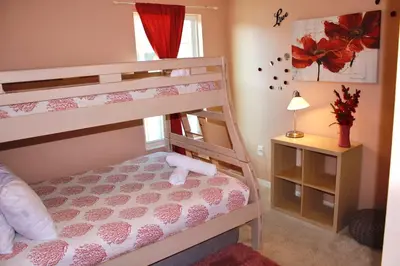a bedroom with two bunk beds and a window at Margaritaville House Close to Universal in Kissimmee