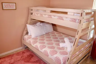 a bedroom with a bunk bed with a ladder at Margaritaville House Close to Universal in Kissimmee