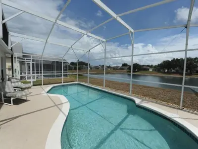 a swimming pool in a house with a view of the water at Holiday Hideout by Paradise Resort Vacations in Orlando