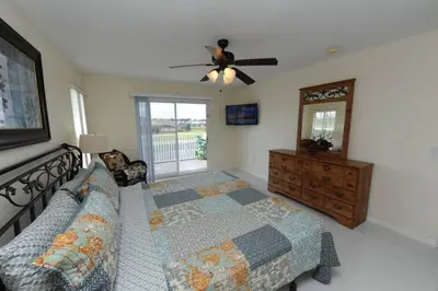 a bedroom with a bed and a ceiling fan at Ruby-Rose Retreat by Paradise Resort Vacations in Kissimmee