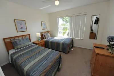 a bedroom with two beds and a window at Ruby-Rose Retreat by Paradise Resort Vacations in Kissimmee