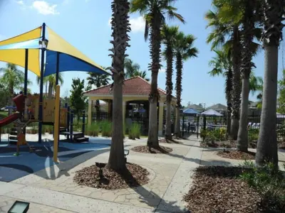 a park with palm trees and a playground at Sunshine Serenity by Paradise Resort Vacations in Kissimmee