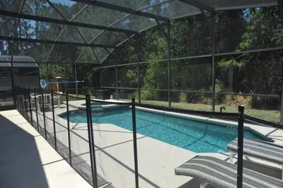 a swimming pool in a building with a glass enclosure at Sunshine Serenity by Paradise Resort Vacations in Kissimmee