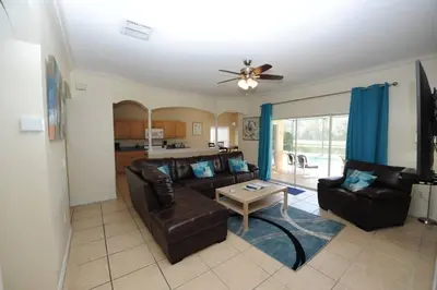 a living room with a couch and a table at Tranquil Waters Haven by Paradise Resort Vacations in Kissimmee
