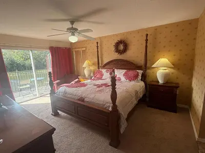 a bedroom with a large bed with pink pillows at Tranquil Waters Haven by Paradise Resort Vacations in Kissimmee